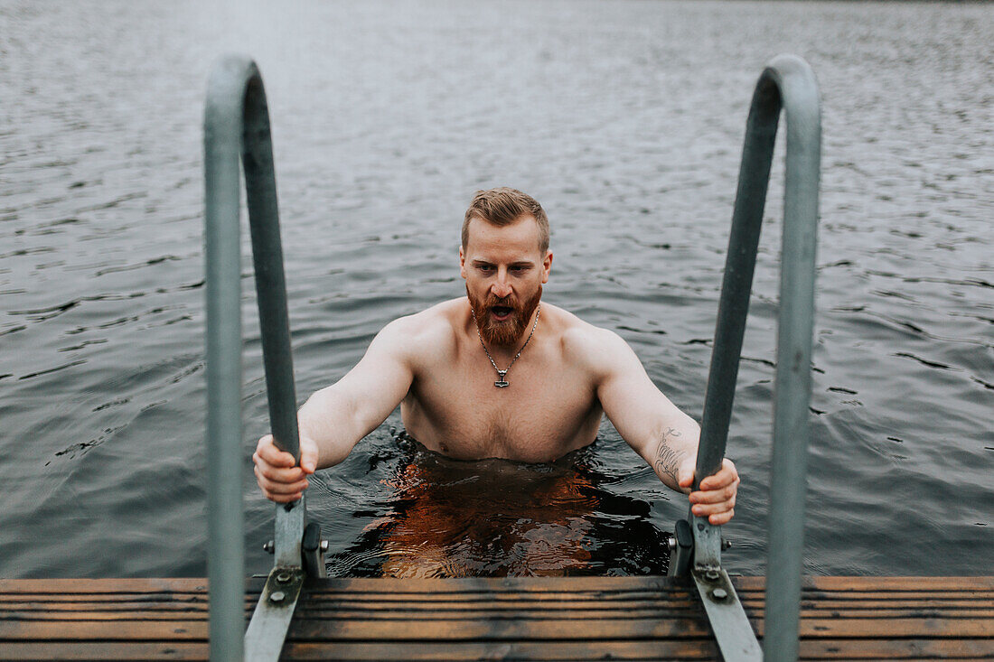 Man in lake looking away