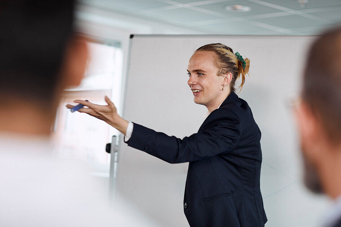 Smiling man having presentation at meeting