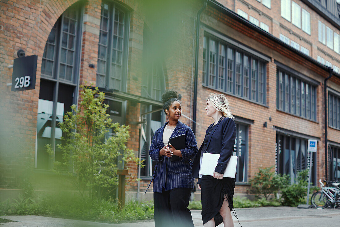 Female coworkers walking together