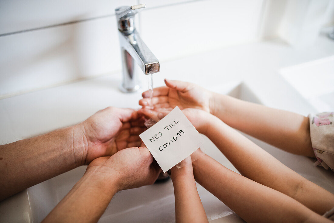 Father and child wash their hands