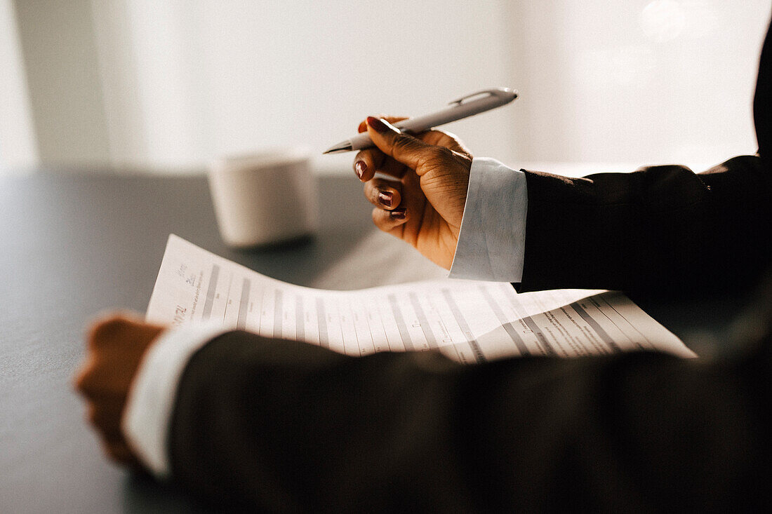 Woman's hands holding documents