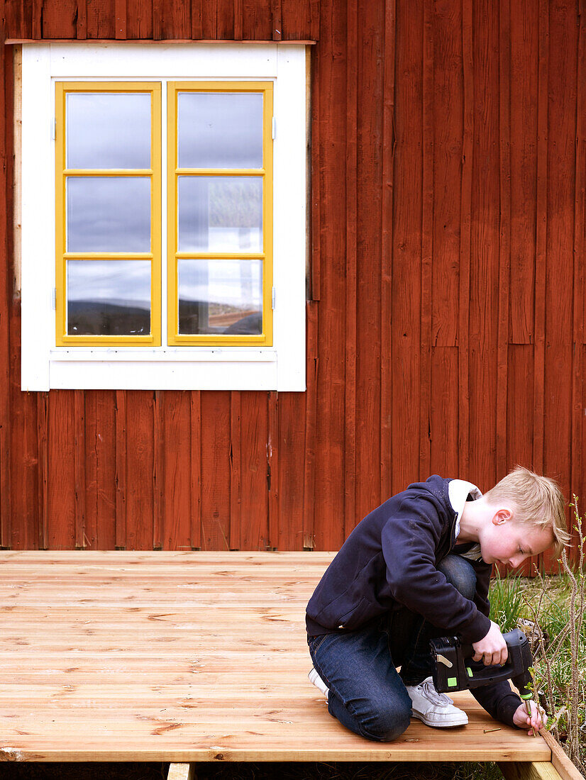 Boy helping out with building work