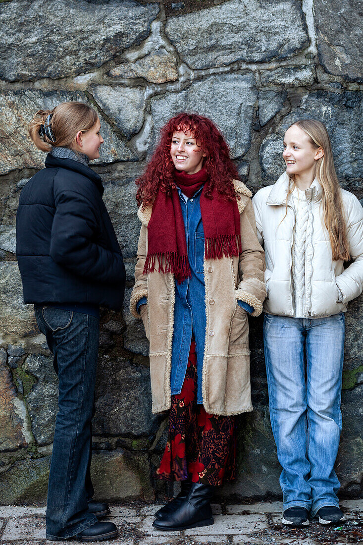 Young female friends talking outdoors