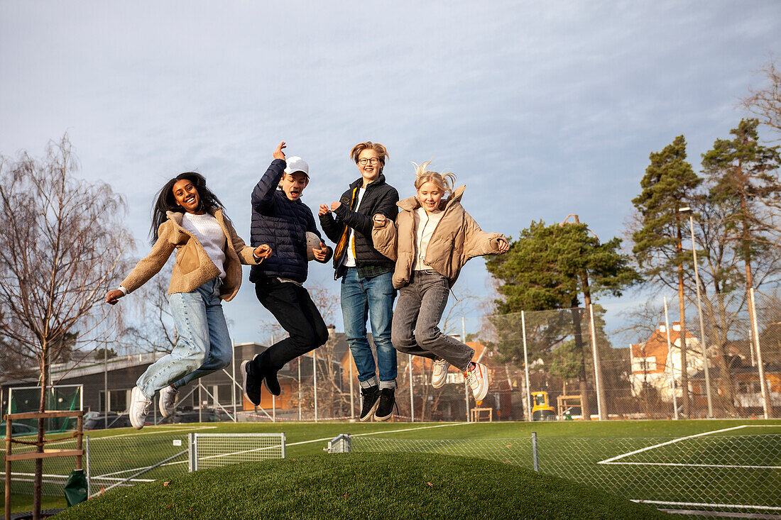 Portrait of teenage friends jumping