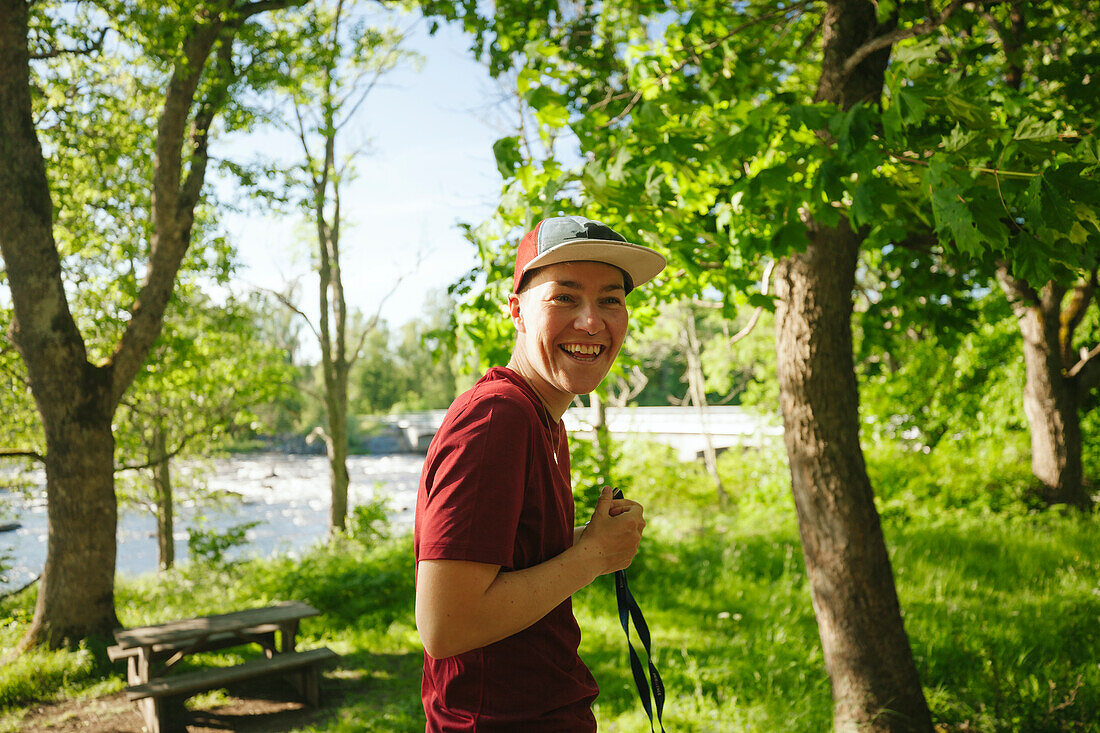 Young man laughing at lakeside