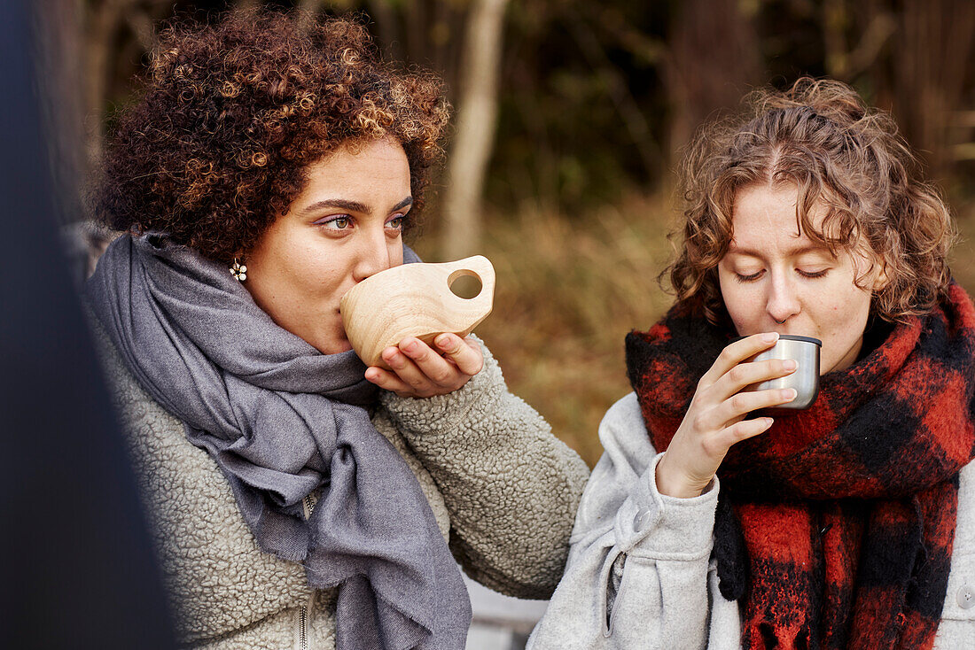 Female friends drinking hot drinks