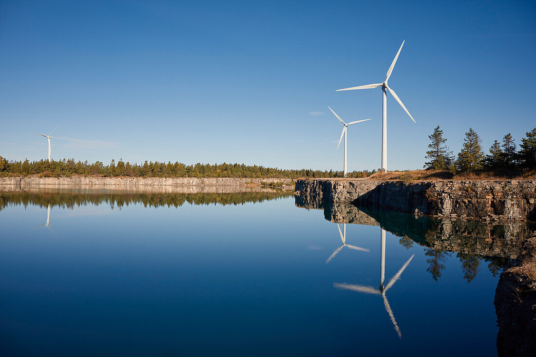 View of wind turbine reflecting in water