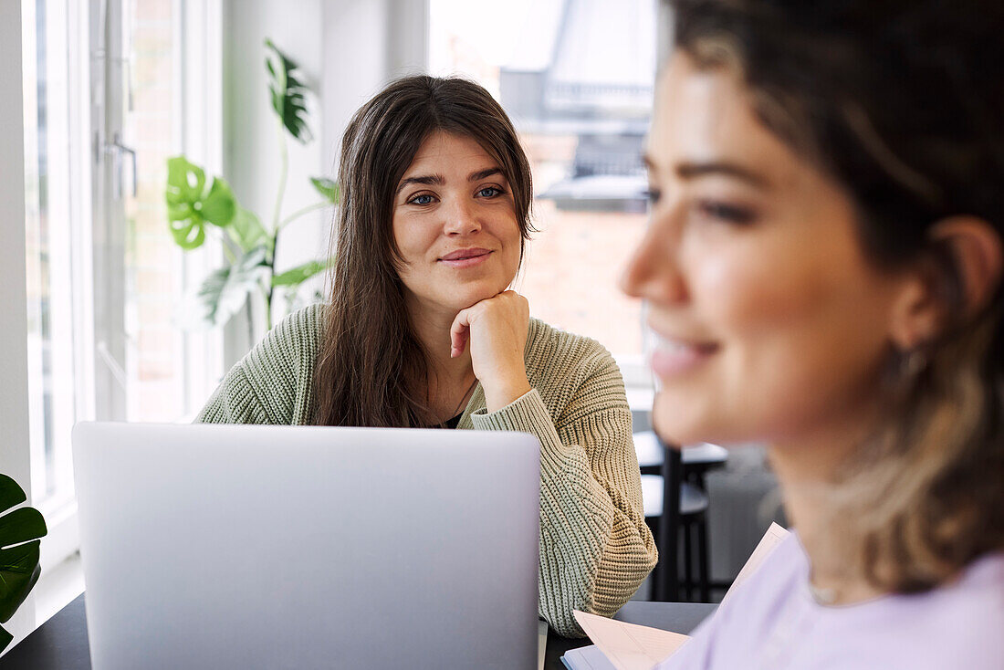 Smiling woman using laptop