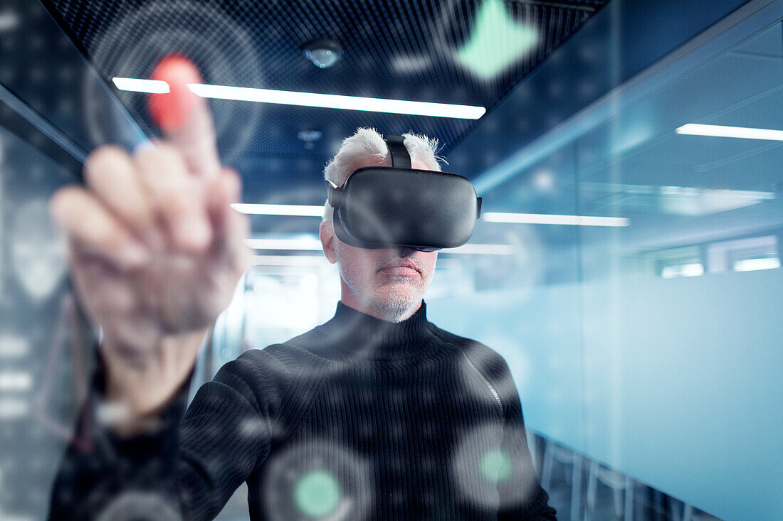 Senior man in virtual reality headset using advanced technology