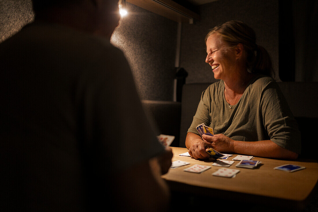 Happy woman playing cards
