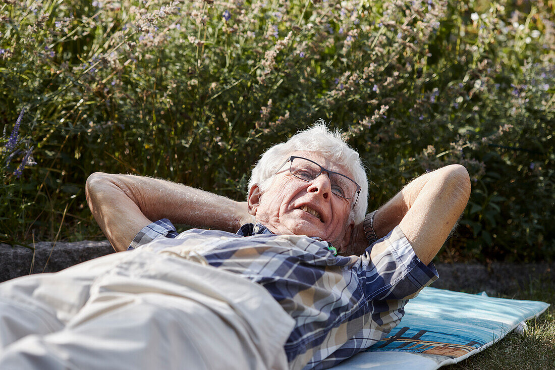 Senior man lying on lawn