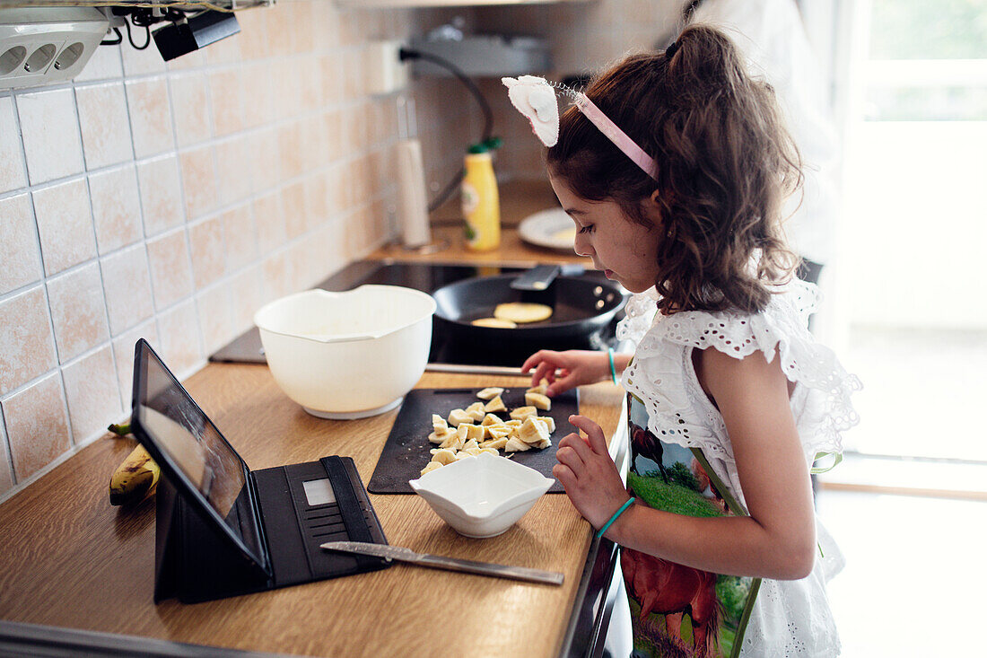 Girl preparing food in kitchen