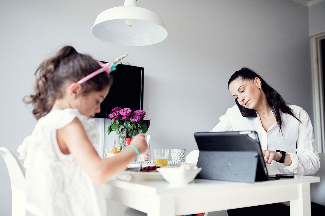 Mother and daughter at dining table