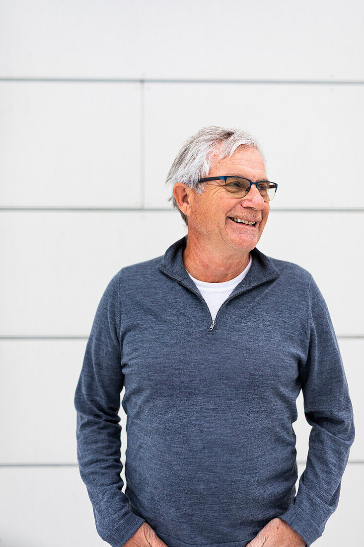 Smiling senior man in gray sweater