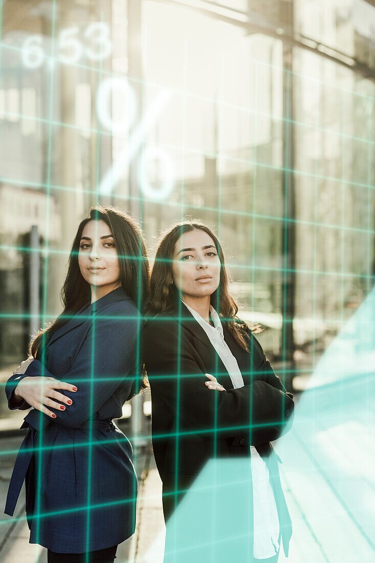 Portrait of young businesswomen in front of office