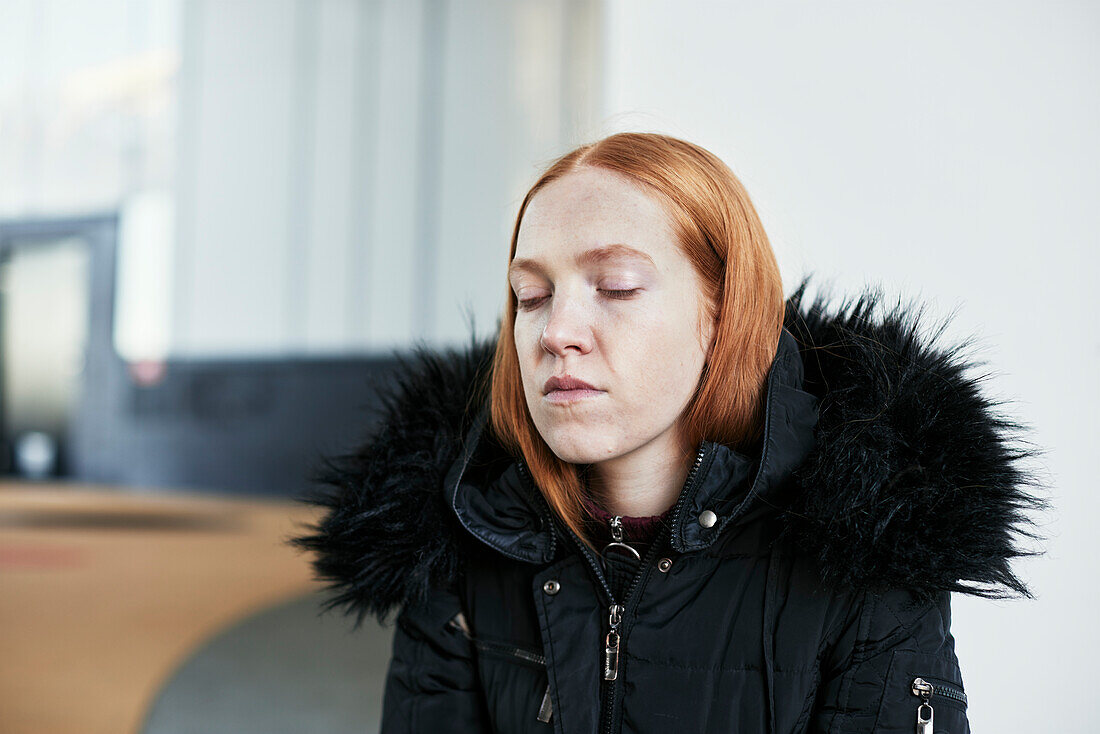 Young woman with eyes closed