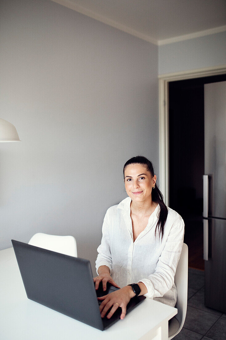 Woman at table using laptop