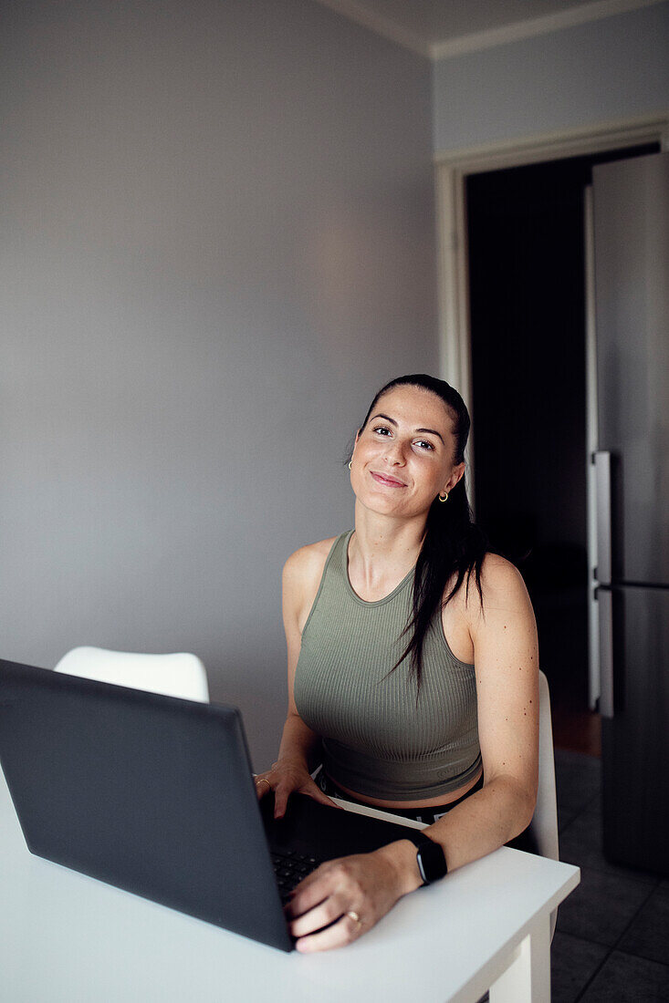 Woman at table using laptop