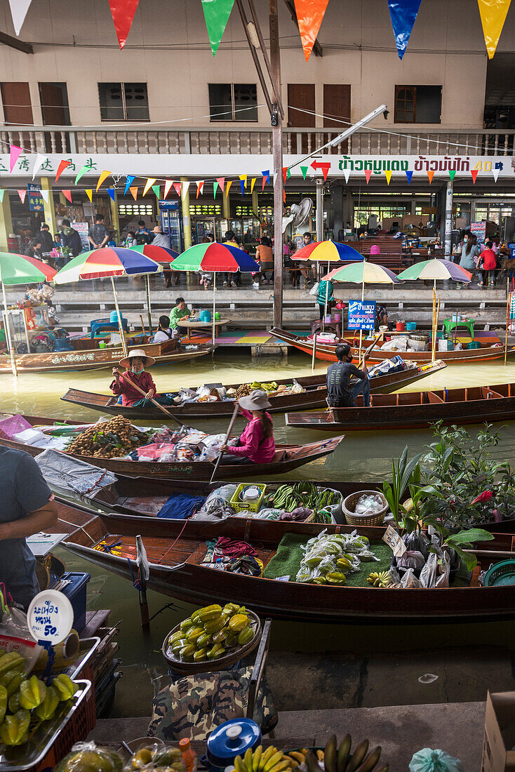 People in boats shopping at farmer's market along canal