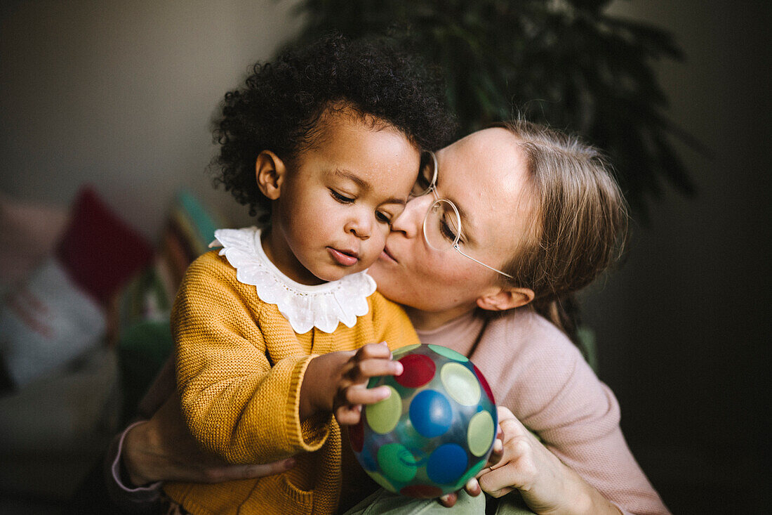 Mother kissing daughter on cheek