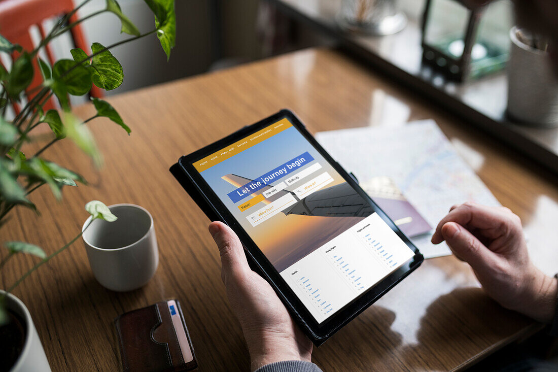 Man searching for flights on tablet