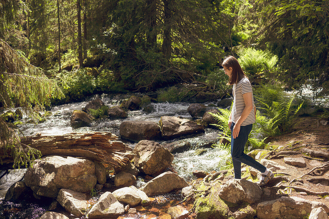 Young man at forest river