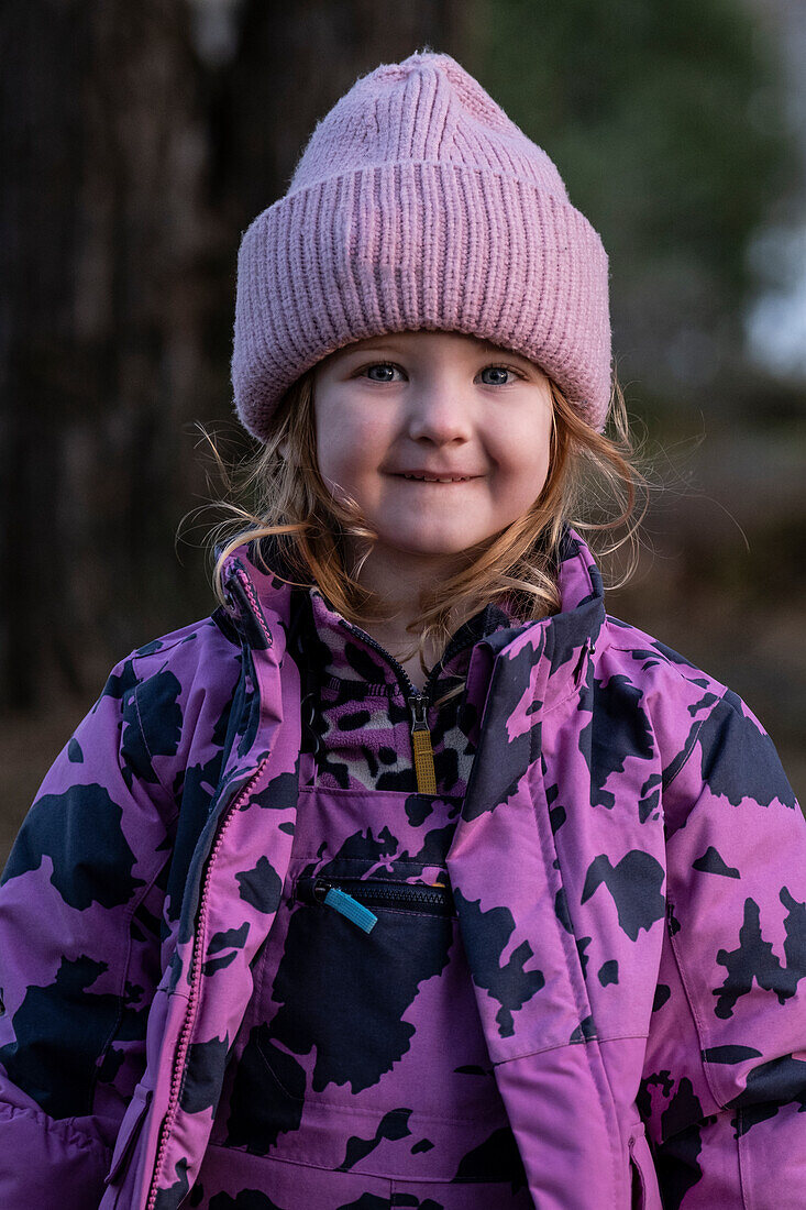 Portrait of smiling girl in pink knit hat