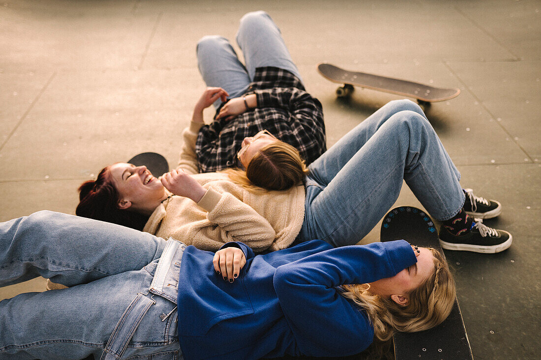 Teenager-Mädchen mit Skateboards entspannen sich im Skatepark