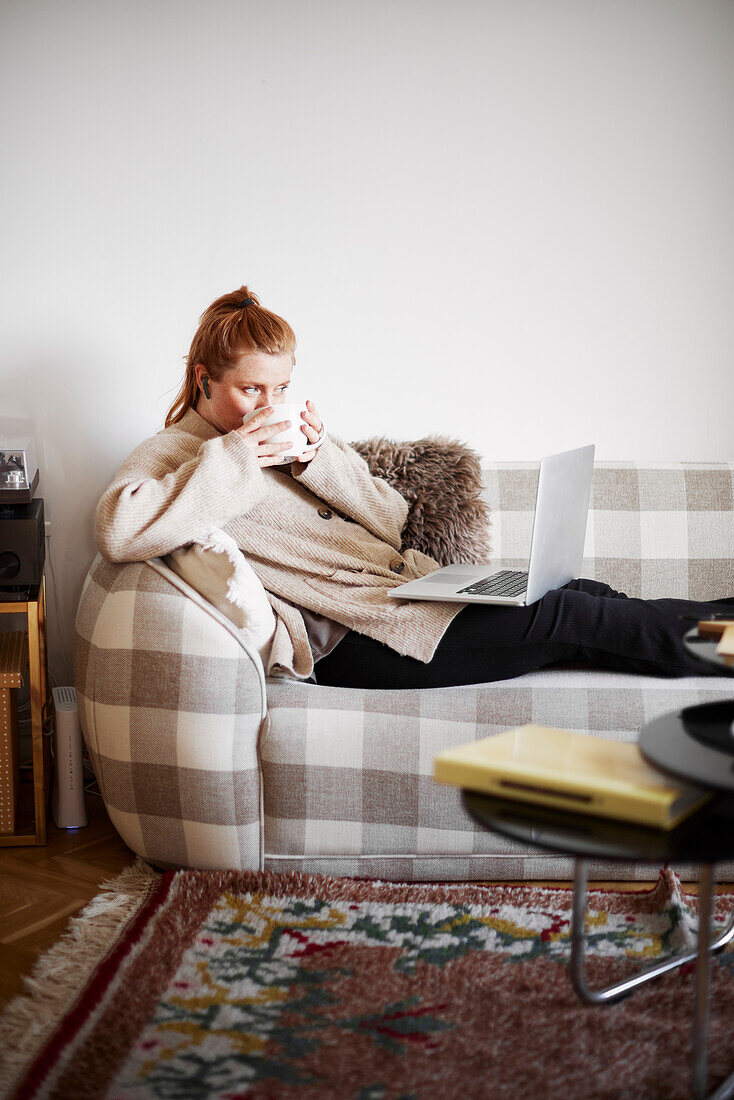 Frau auf dem Sofa mit Laptop