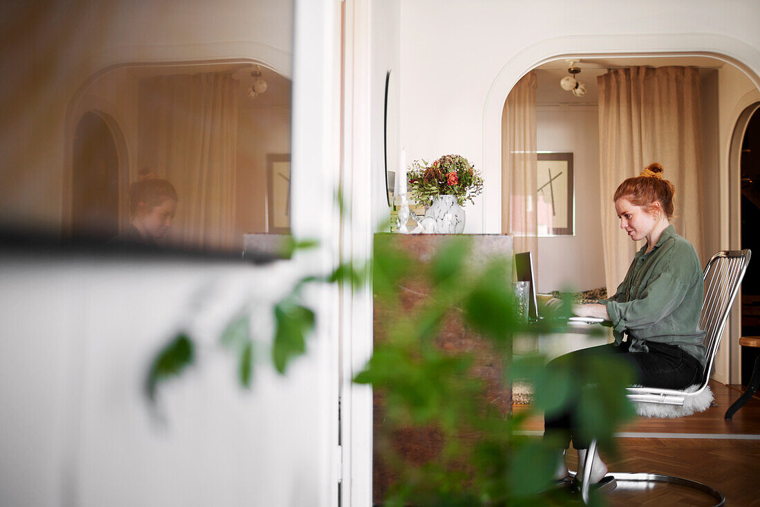 Woman using laptop in living room