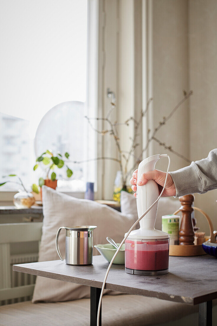 Hand holding blender