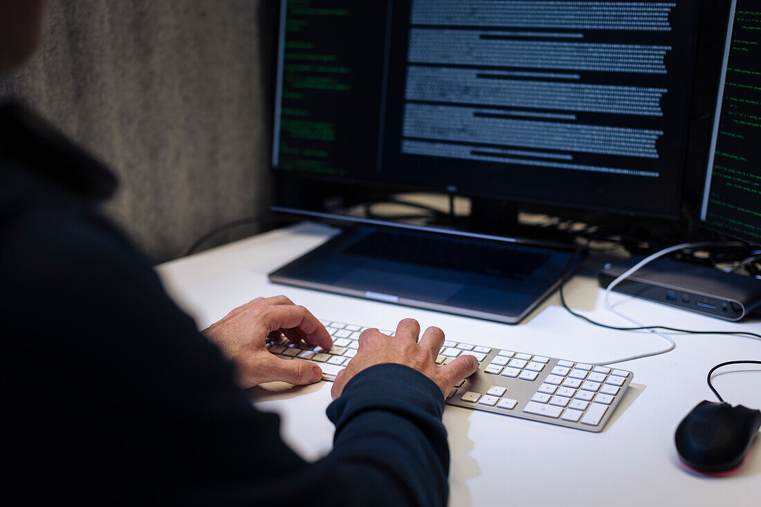 Male programmer working on computer