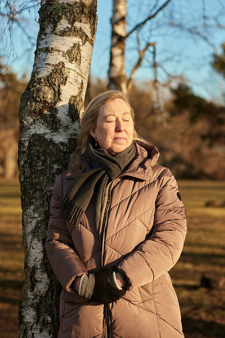 Woman standing with eyes closed