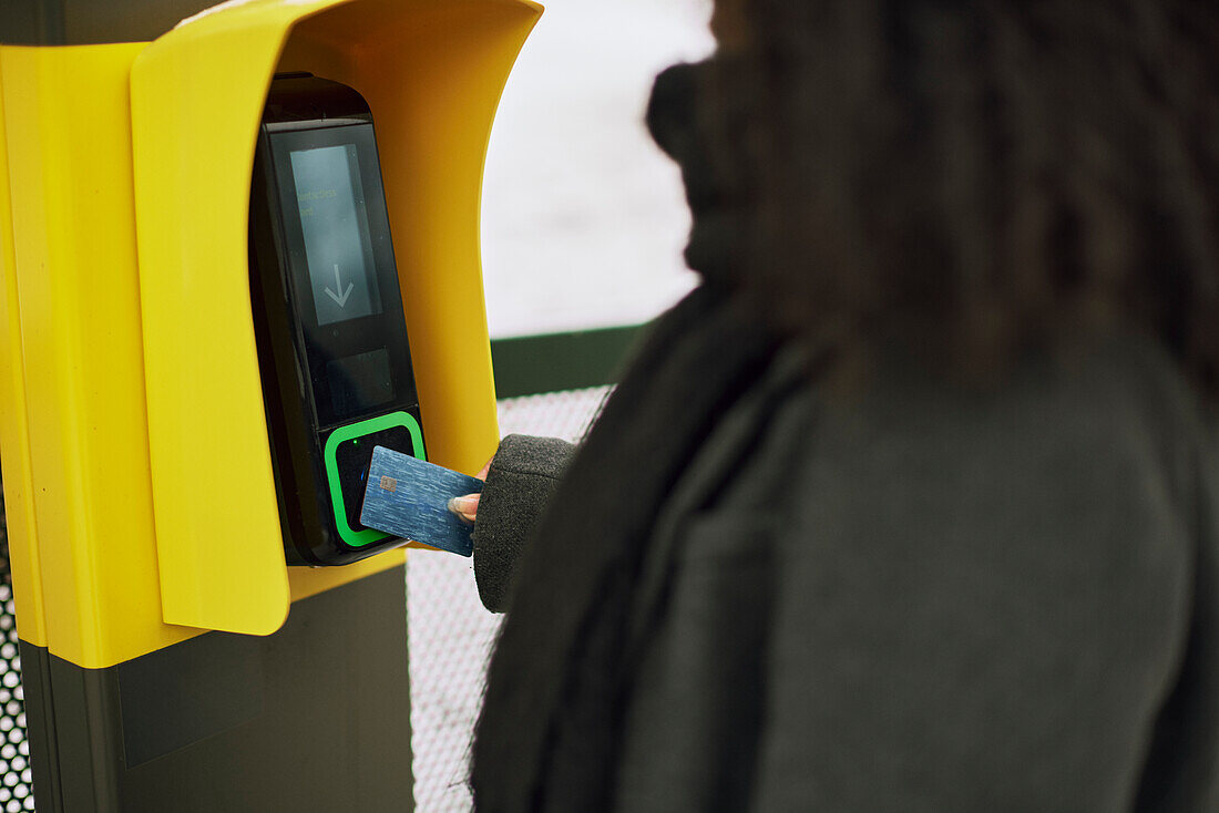 Woman paying for ticket with credit card