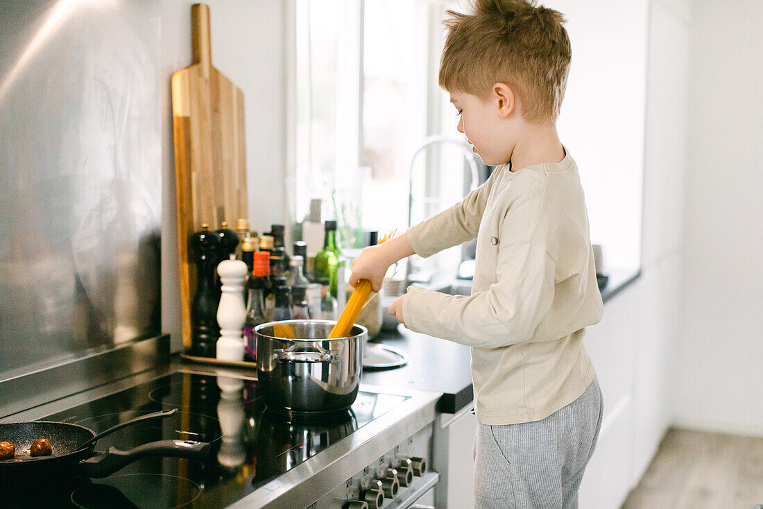 Boy preparing food in kitchen