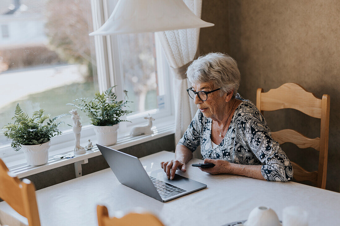 Senior woman using laptop