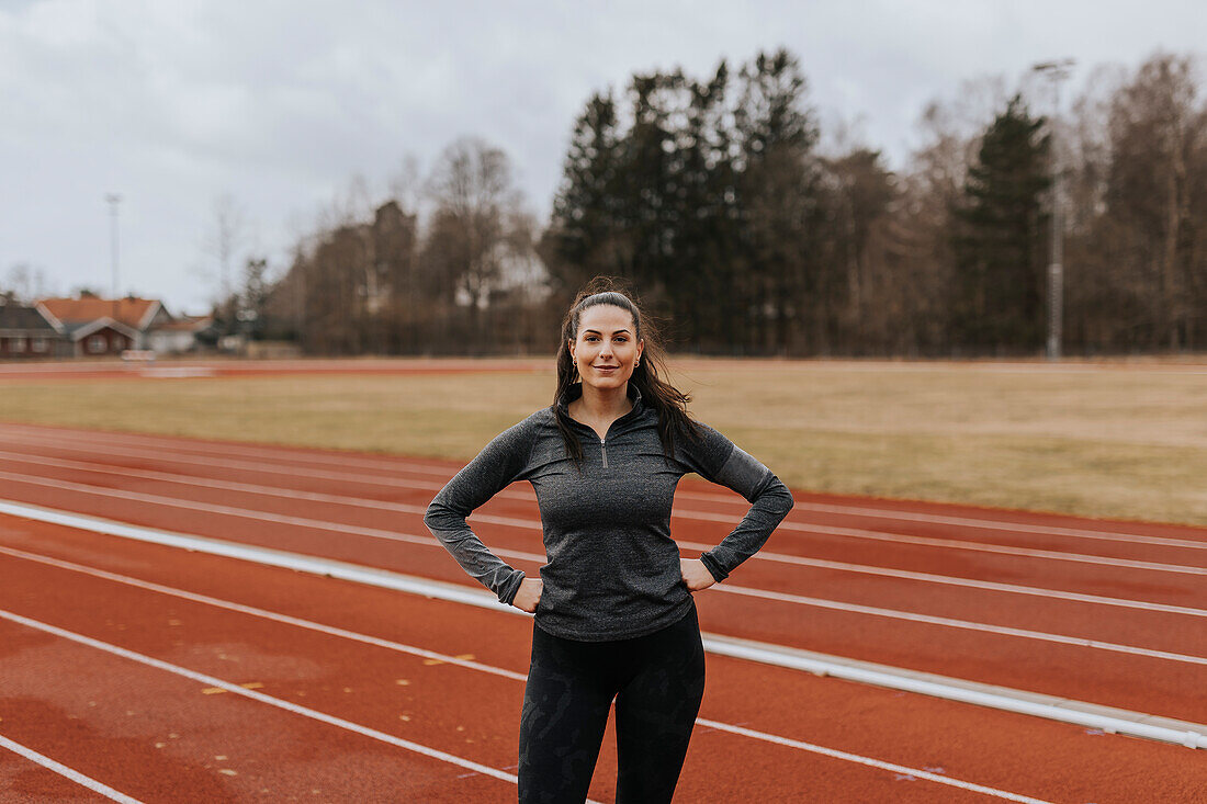 Woman standing at running track