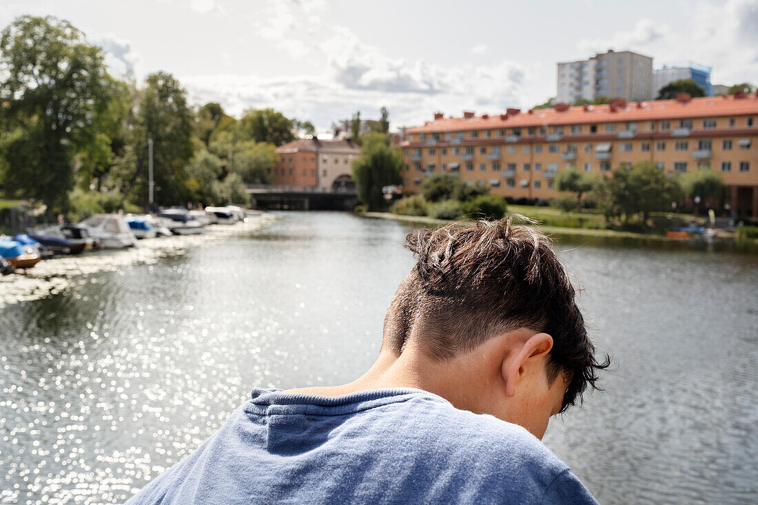 Rear view of boy and river