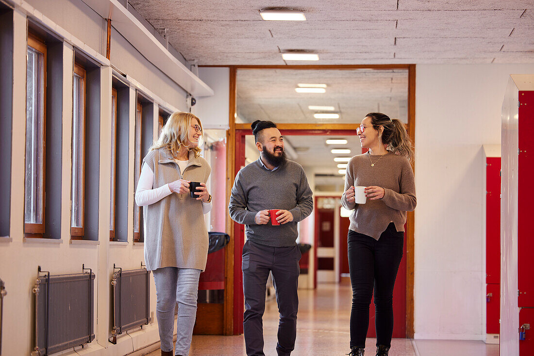 Co-workers talking at corridor