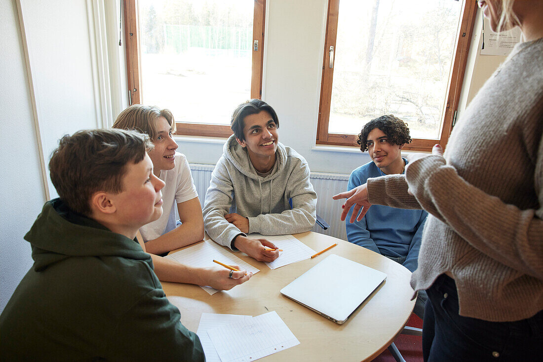 Lehrerin im Gespräch mit Schülern in der Klasse