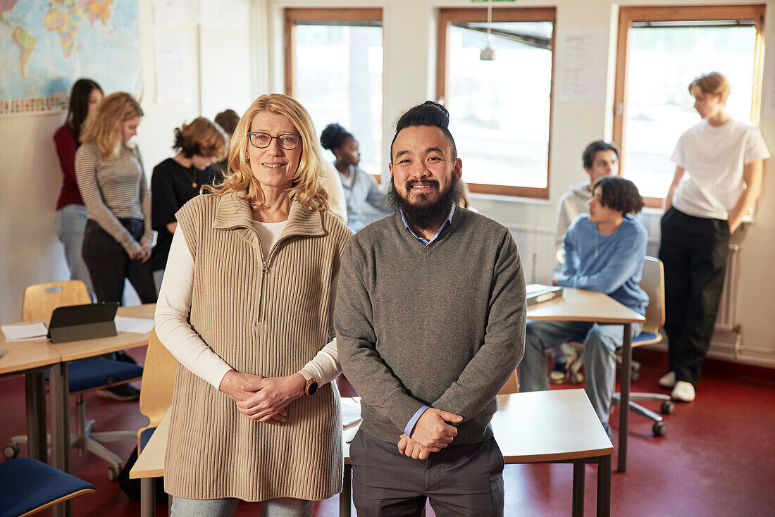 Portrait of teachers with students in background