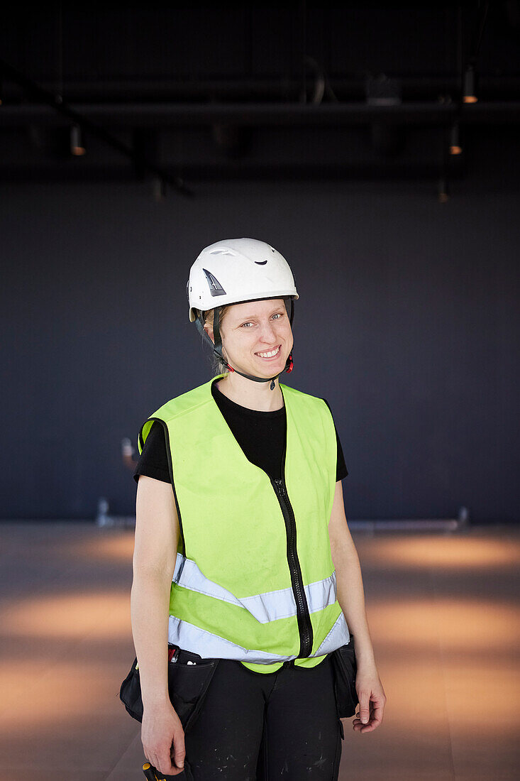 Smiling female worker looking at camera