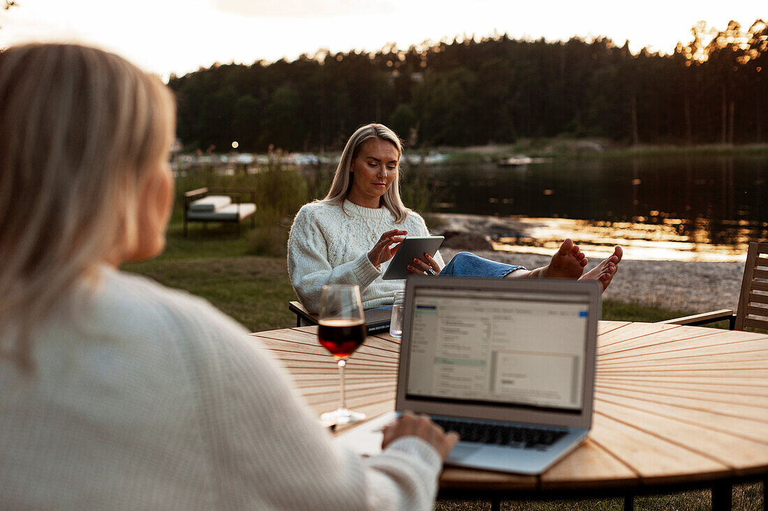 Women sitting at lake