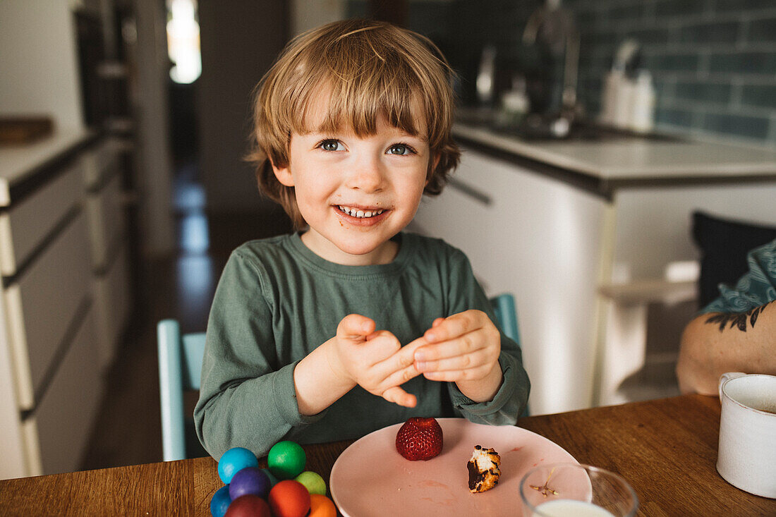 Smiling boy sitting at table