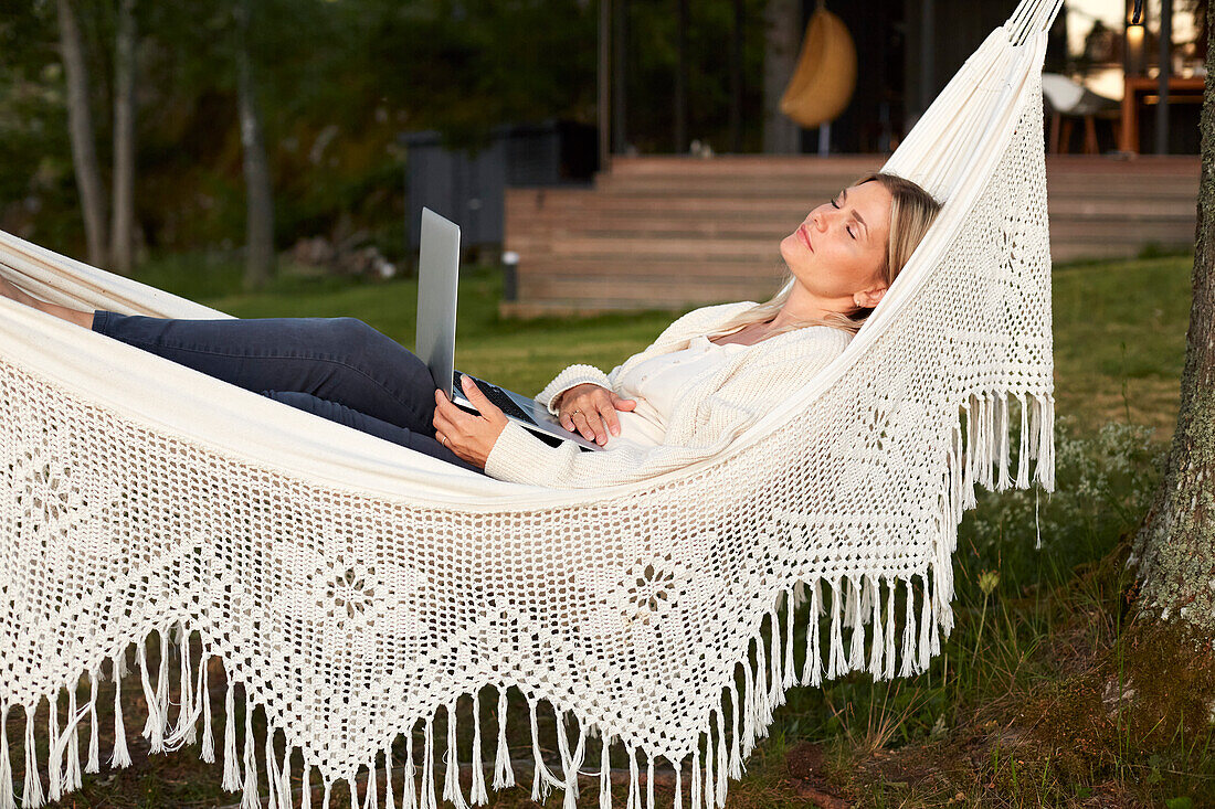 Woman relaxing on hammock