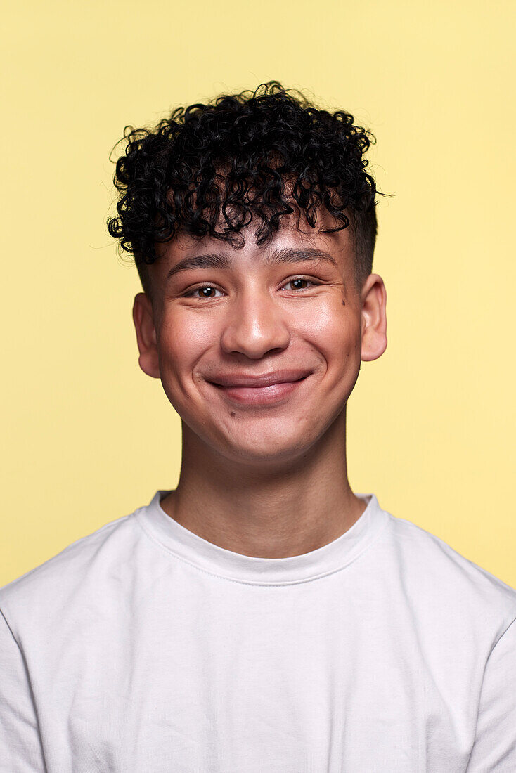 Portrait of boy against yellow background