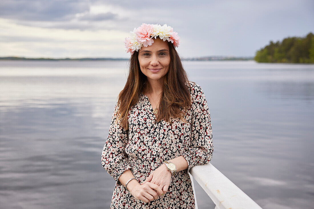 Smiling woman standing at lake