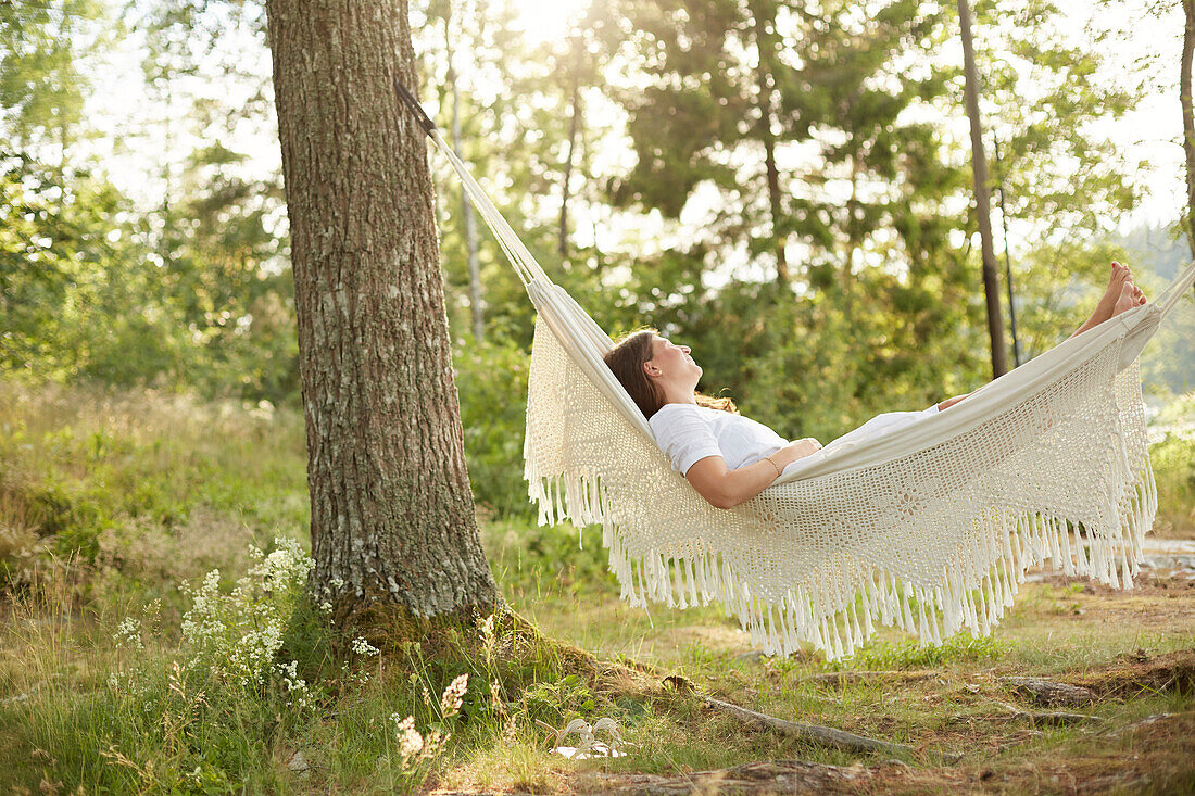 Woman relaxing in hammock