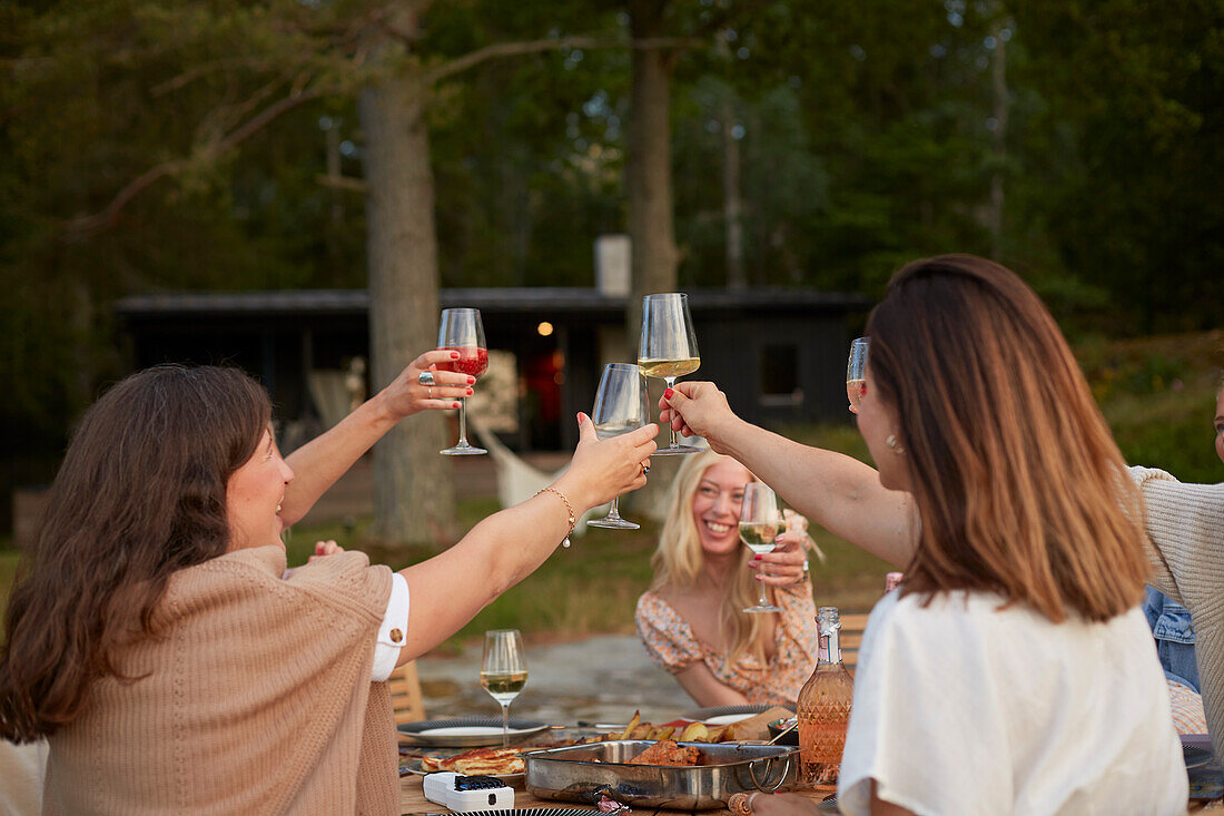 Female friends having toast outdoors