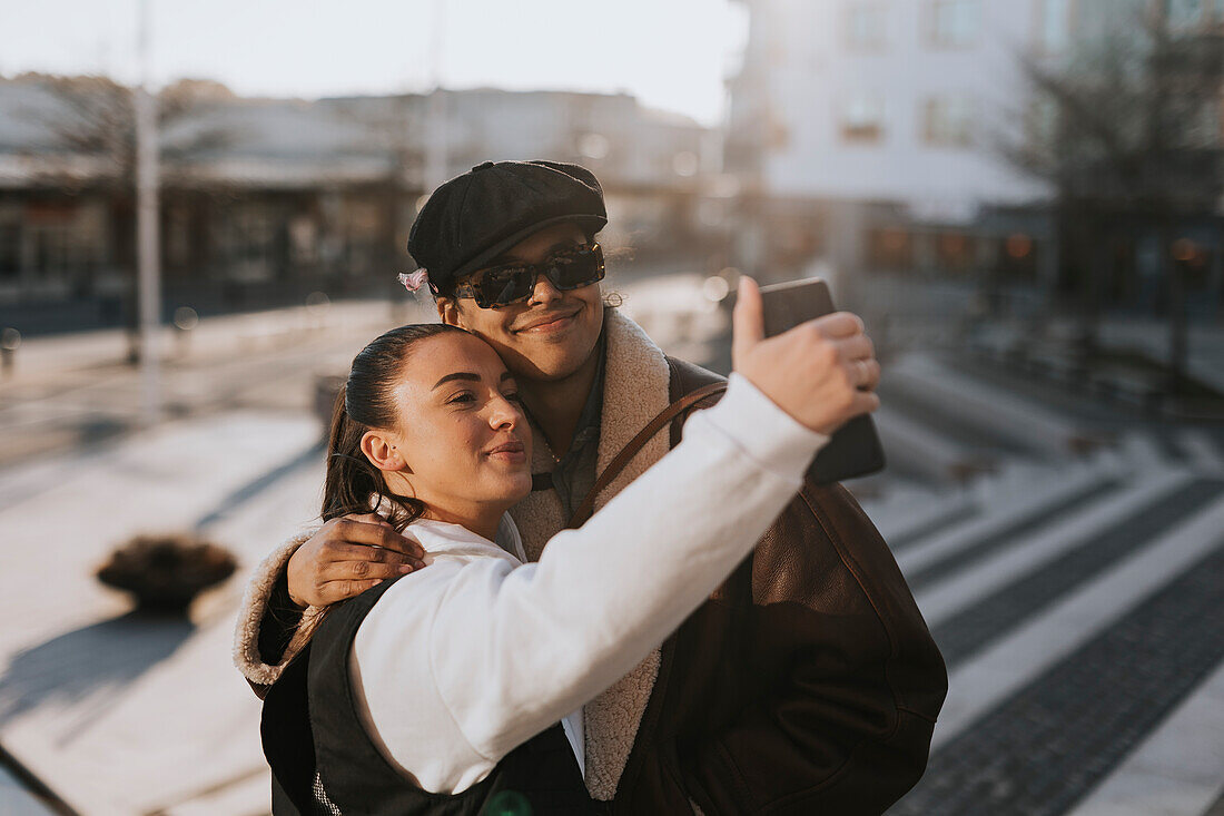 Smiling friends taking selfie